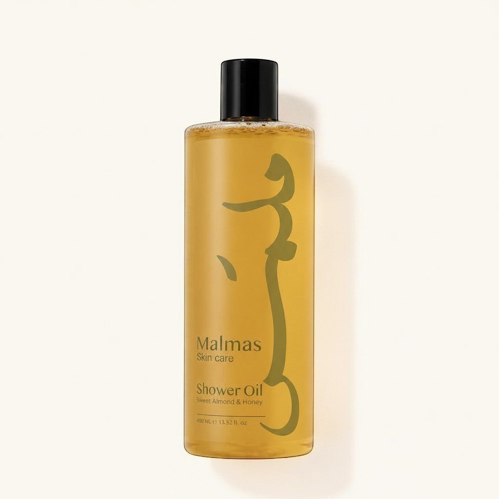 Malmas Sweet Almond & Honey Shower Oil 400ml bottle with a golden hue and a minimalist green design.